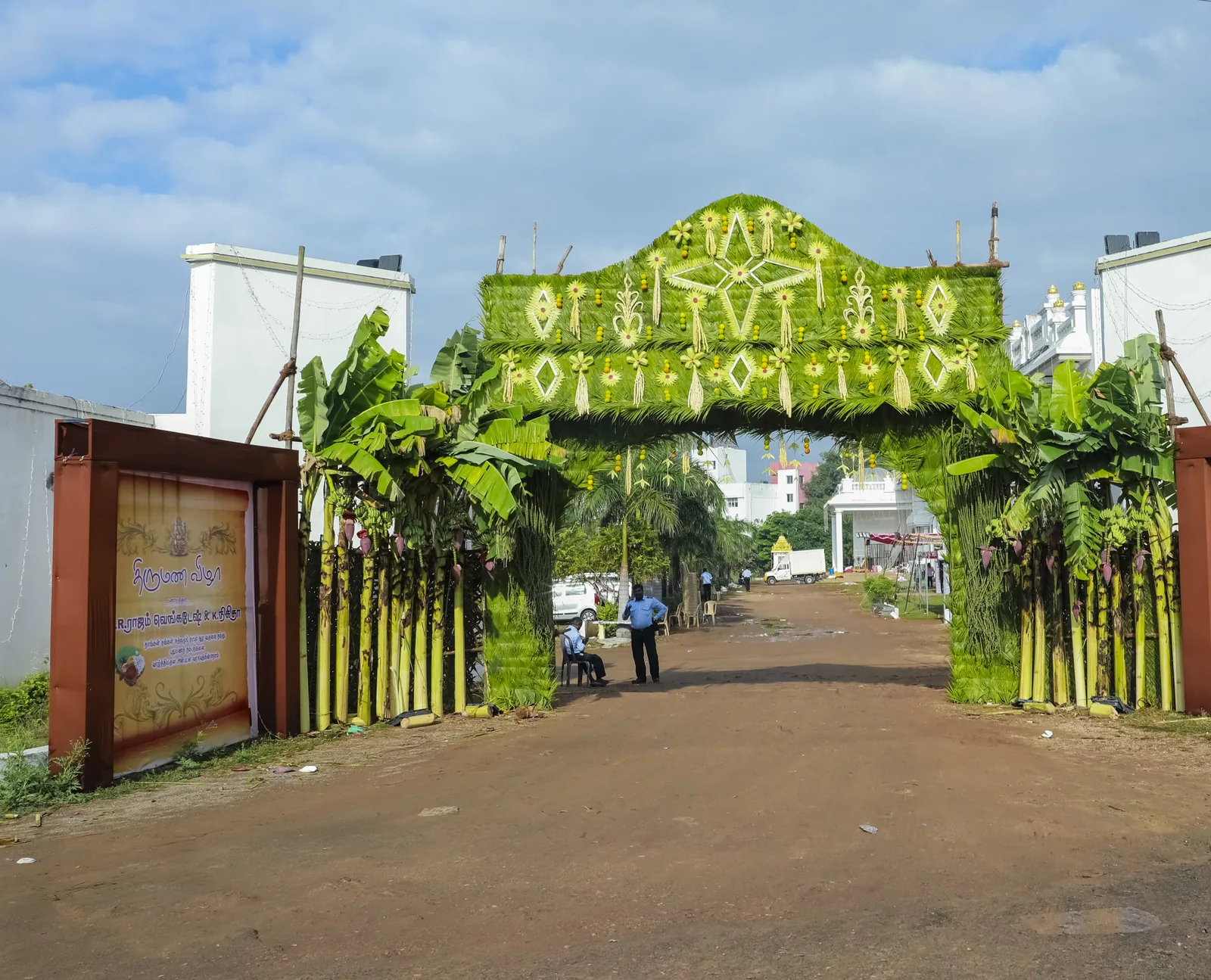 A green floral entrance arch at a Tiruchirappalli wedding venue