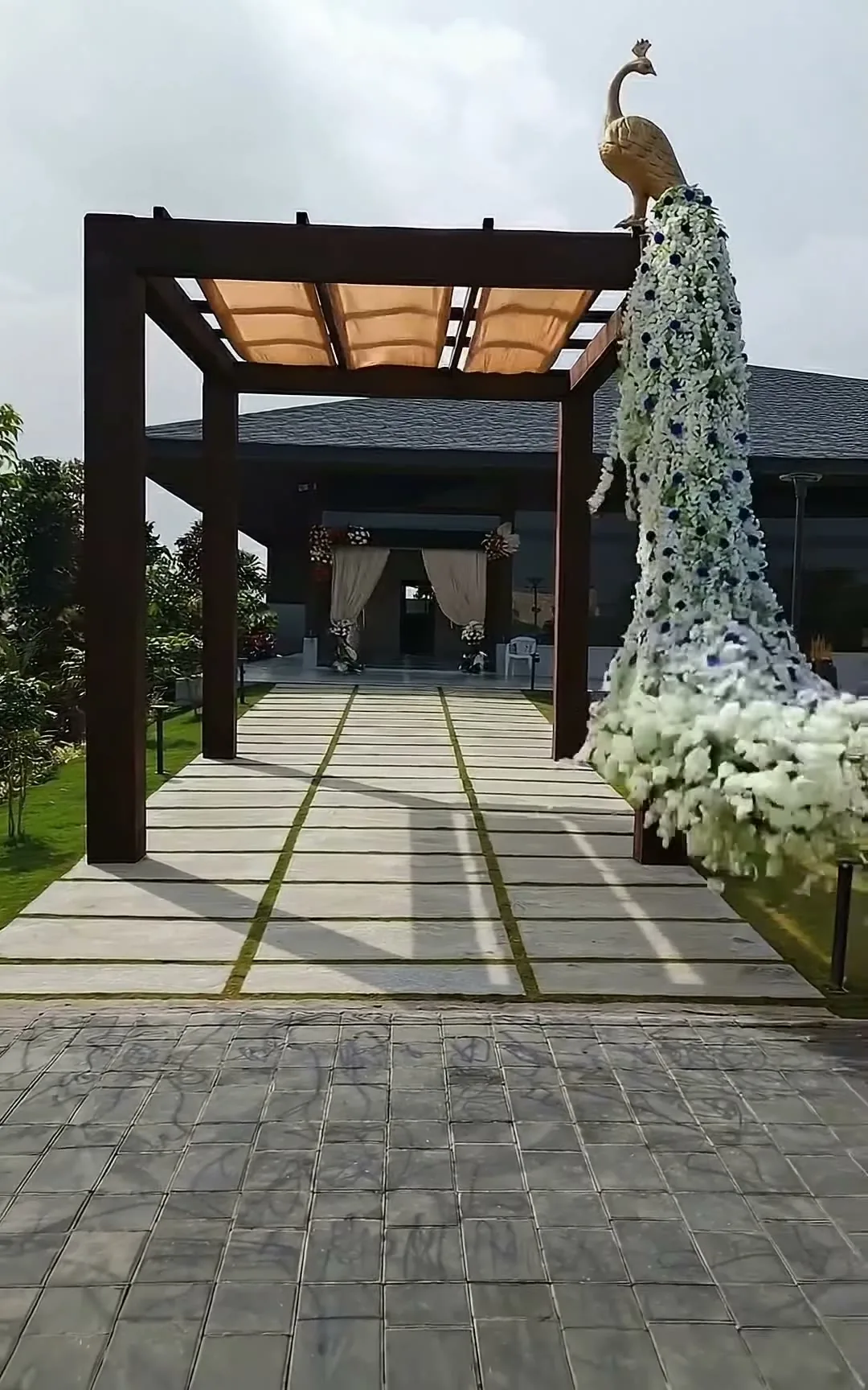 A venue entrance with a white floral peacock sculpture